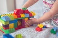 Baby builds house from designer, close-up, real Royalty Free Stock Photo