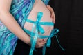 Baby Bump with two blue ribbons