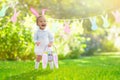 Baby with bunny ears on garden Easter egg hunt Royalty Free Stock Photo