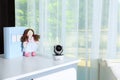 Baby camera with toy and photo on chest of drawers in room, space for text. Video nanny