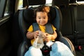 Asian Baby Girl Seated in Safe Toddler Seat In Auto