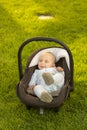 Baby in car seat on grass Royalty Free Stock Photo