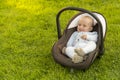 Baby in car seat on grass Royalty Free Stock Photo