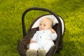 Baby in car seat on grass Royalty Free Stock Photo