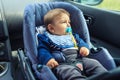 Baby car seat for safety. Happy Boy sitting in a car in safety chair. Protection in the car Royalty Free Stock Photo