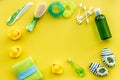 Baby care accessories, toys and clothing on yellow background top view mock up Royalty Free Stock Photo