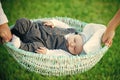 Baby care. Baby boy sleep in crib held in hands
