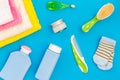 Baby care. Bath cosmetics and accessories for child. Shampoo, gel, cream, towel, brush on blue background top view Royalty Free Stock Photo