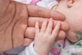 Baby care concept. Child holds hand of her father Royalty Free Stock Photo