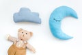 Baby care concept with moon pillow, clouds, teddy bear and toy for sleep of newborn on white background top view Royalty Free Stock Photo