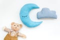 Baby care concept with moon pillow, clouds, teddy bear and toy for sleep of newborn on white background top view Royalty Free Stock Photo