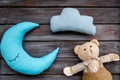 Baby care concept with moon pillow, clouds, teddy bear and toy for sleep of newborn on wooden background top view Royalty Free Stock Photo