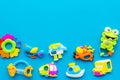Baby care with craft toys for newborn. Rattle. Blue background top view copy space Royalty Free Stock Photo