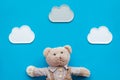 Baby care. Newborn baby concept. Baby sleep concept. Teddy bear toy near clouds on blue background top view Royalty Free Stock Photo