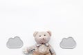 Baby care. Newborn baby concept. Baby sleep concept. Teddy bear toy near clouds on white background top view copy space