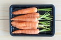 Baby carrots in a black container