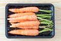 Baby carrots in a black container vintage filter applied