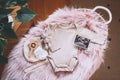 Baby changing basket with ultrasound image, baby bodysuit, soft and wooden toys. Still life of child products. Newborn background