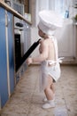 Baby chef cooks in the oven food Royalty Free Stock Photo