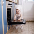 Baby chef cooks in the oven food Royalty Free Stock Photo