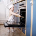 Baby chef cooks in the oven food Royalty Free Stock Photo