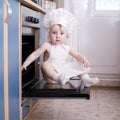 Baby chef cooks in the oven food Royalty Free Stock Photo