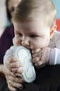 Baby chewing on shoes