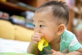 Baby chewing on teething plastic toy Royalty Free Stock Photo