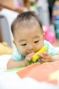 Baby chewing on teething plastic toy Royalty Free Stock Photo