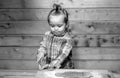 Baby child boy cooking, playing with flour at wooden kitchen. Royalty Free Stock Photo