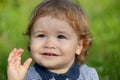 Baby child boy enjoy the summer on the nature in the park outdoor. Baby face close up. Funny little child closeup Royalty Free Stock Photo