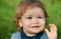 Baby child boy enjoy the summer on the nature in the park outdoor. Baby face close up. Funny little child closeup Royalty Free Stock Photo