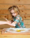 Baby child cooking, playing with flour at wooden kitchen. Royalty Free Stock Photo