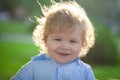 Baby child enjoy the summer on the nature in the park outdoor. Baby face closeup. Funny little child close up portrait Royalty Free Stock Photo