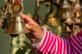 A BABY CHILD GIRL HAND TOUCHES A BIG BRASS BELL 3