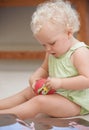 Baby, child and girl play with toys in home, adorable and cute kid alone in house. Young blonde toddler, game and Royalty Free Stock Photo