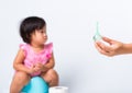 Baby child girl training to sitting on blue chamber pot or potty her problem cannot shit and mother use Enema Royalty Free Stock Photo