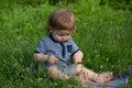 Baby child in green grass on spring lawn. Little kids walking in the park. Children on pirnic. Child exploring nature.