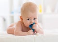 Baby child lying on belly weared diaper with teether Royalty Free Stock Photo