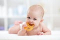 Baby child lying on belly weared diaper with teether Royalty Free Stock Photo