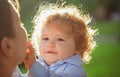 Baby child and mother on sunny day. Kids face, little boy portrait. Childhood and parenting concept. Royalty Free Stock Photo