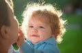 Baby child and mother on sunny day. Kids face, little boy portrait. Childhood and parenting concept. Royalty Free Stock Photo