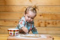 Baby child preparing the dough, bake cookies in the kitchen. Royalty Free Stock Photo