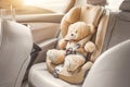 Baby child seat car. A beige teddy bear is fastened with seat belts in a car seat. Travel by car Royalty Free Stock Photo