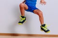 Baby in clean basketball sneakers jumping high on white background Royalty Free Stock Photo