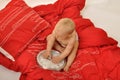 Baby with clock in bed