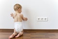 Baby close to electric outlets Royalty Free Stock Photo