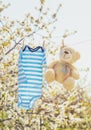 Baby clothes and accessories weigh on the rope after washing in the open air. Selective focus Royalty Free Stock Photo