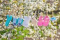 Baby clothes and accessories weigh on the rope after washing in the open air. Selective focus Royalty Free Stock Photo