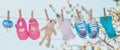 Baby clothes and accessories weigh on the rope after washing in the open air. Selective focus Royalty Free Stock Photo